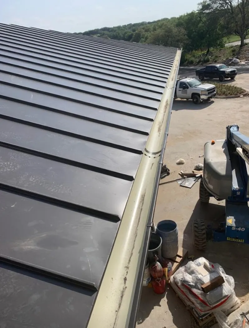 Standing seam panel and gutter detail on a metal roofing jobsite in Hazlet